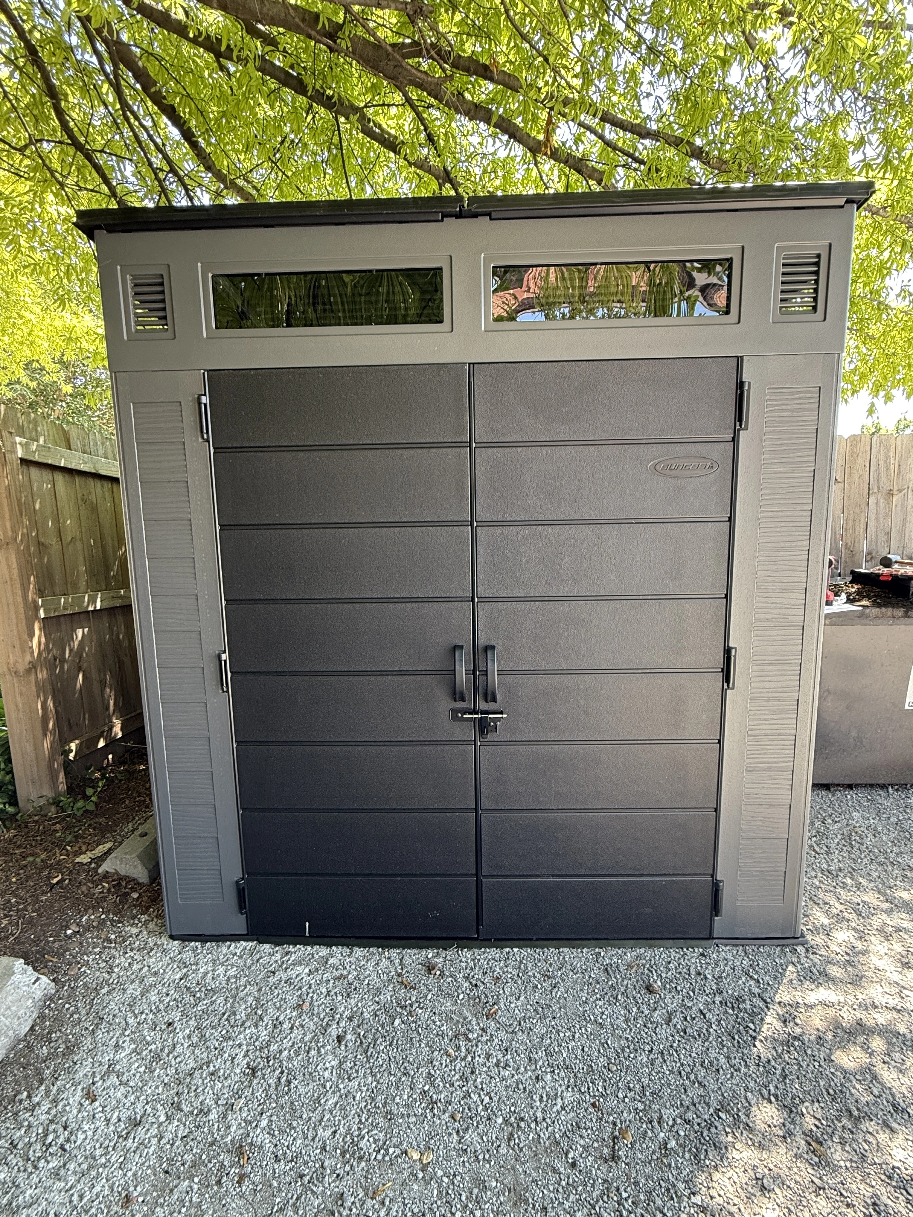 Completed gray storage shed outside the restaurant service area
