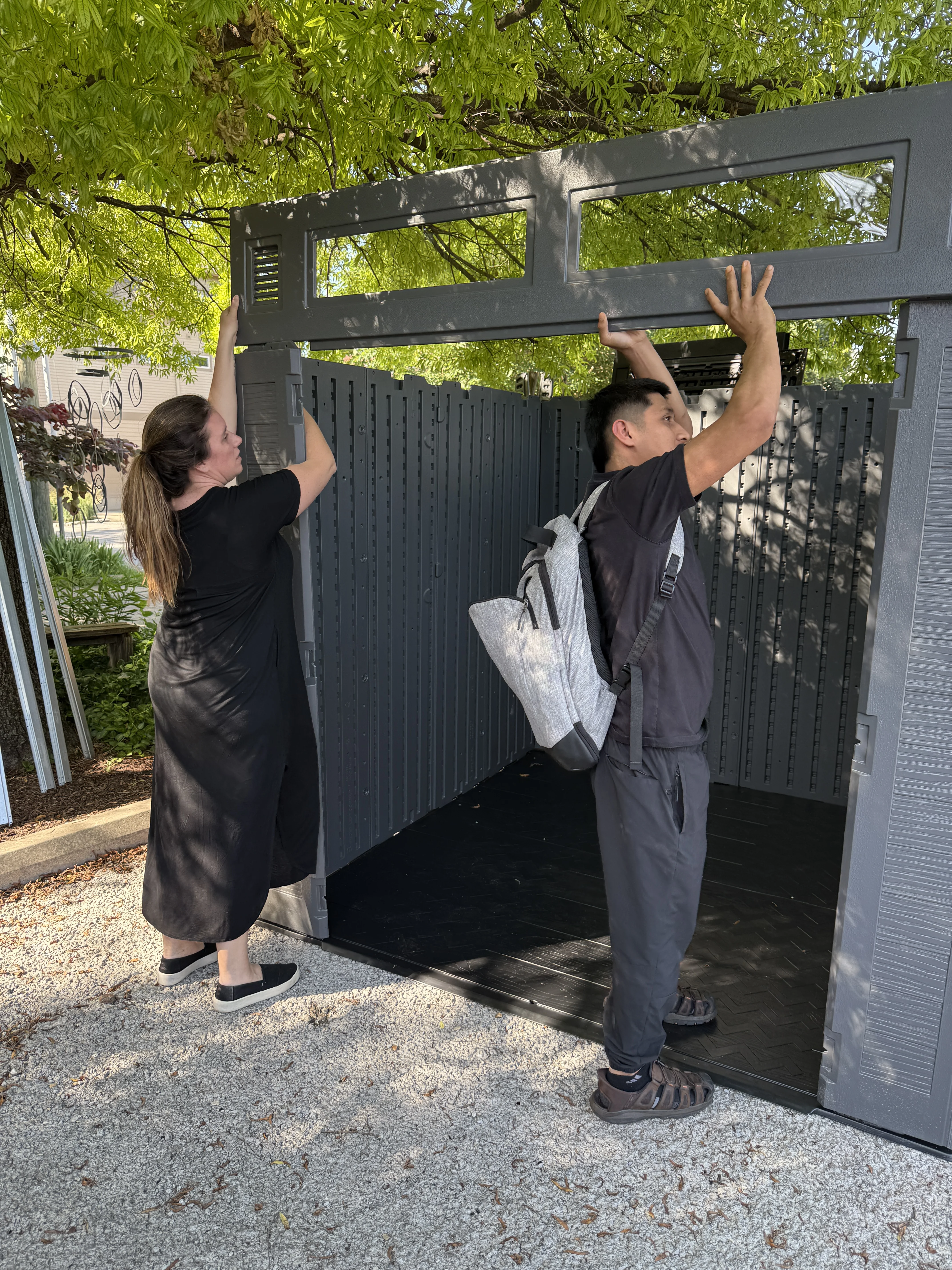 Team members assembling the storage shed together